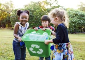 Children collecting bottles in a recycling box