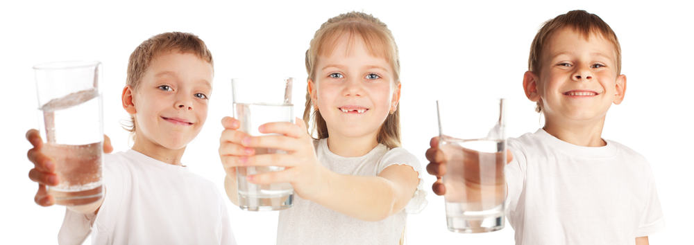 Three children holding glasses of water