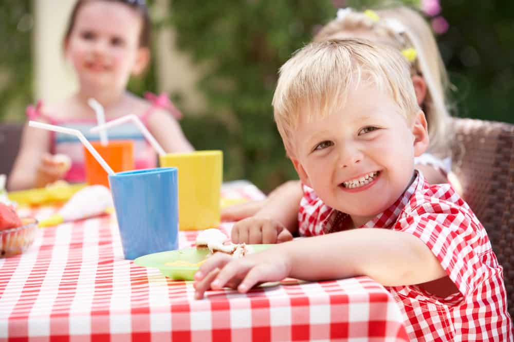 Children sitting around a picnic table