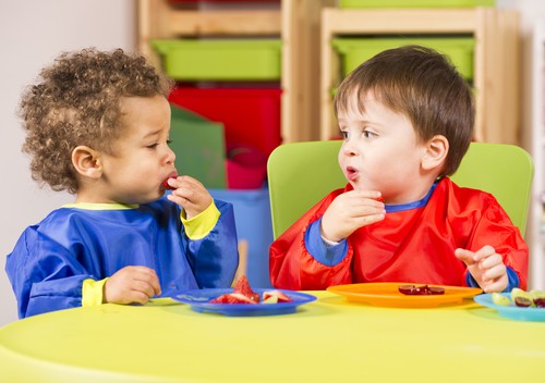 Children eating snacks in nursery