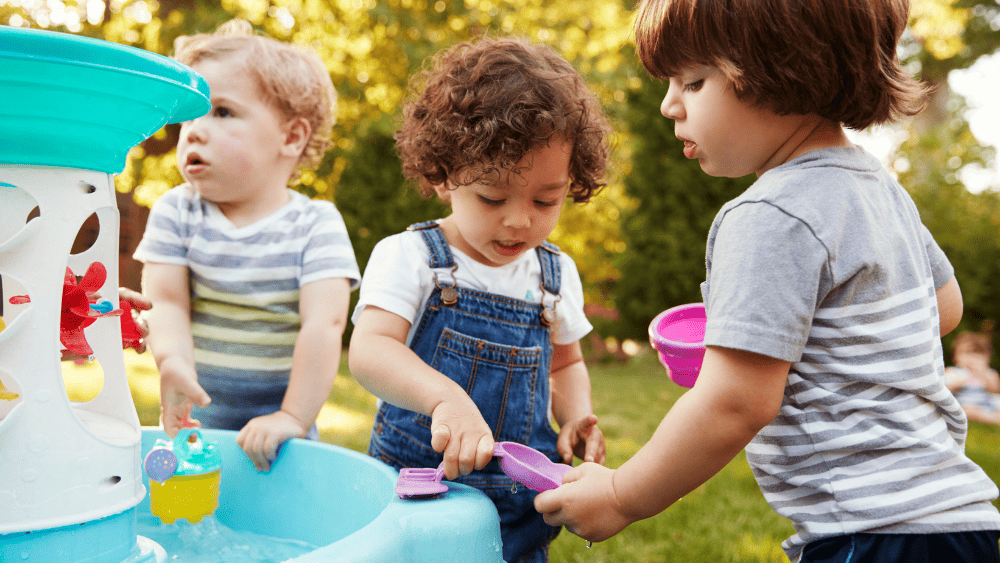 Children playing outside with water toys