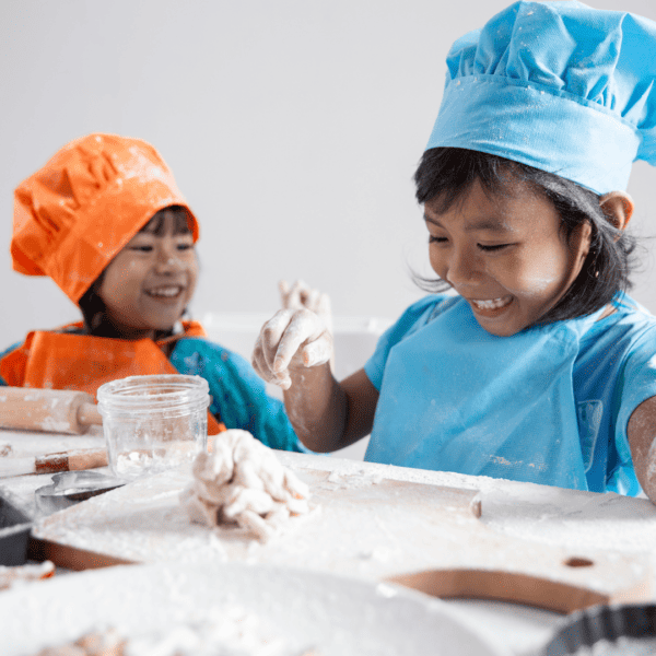 Two girls baking and preparing dough