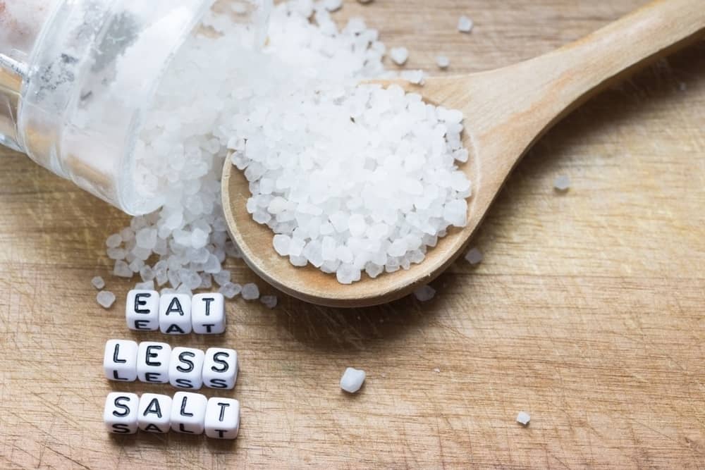 Eat Less Salt Advice Written With Plastic Letters Beads On a Table