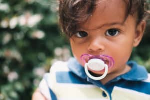 Toddler with dummy in mouth