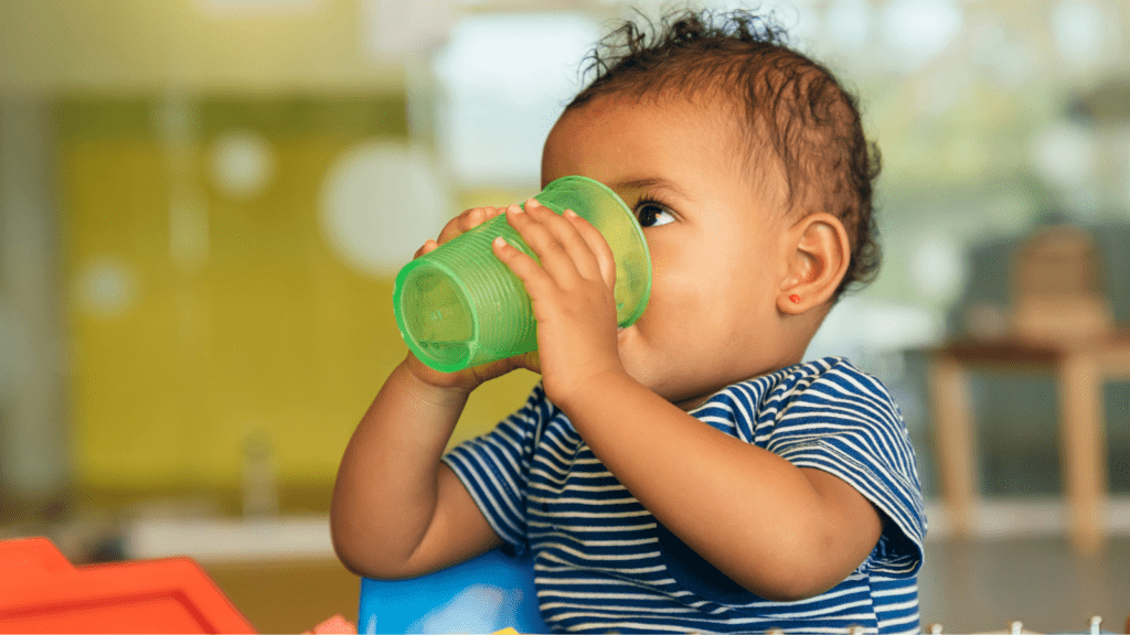 Child drinking from an open-top cup