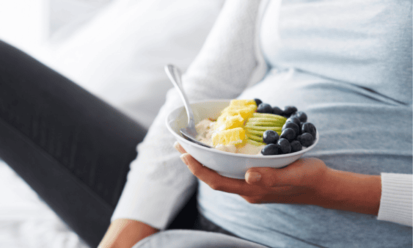 Pregnant woman eating breakfast