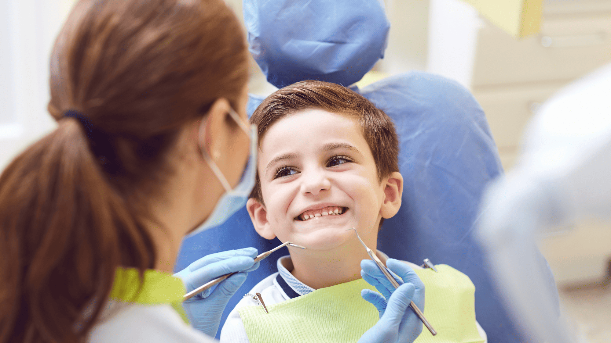 Young boy happy to be visiting the dentist to have his teeth checked